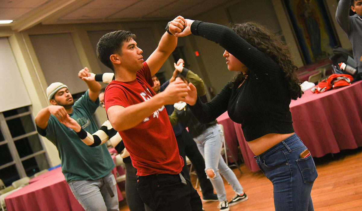 Sixth mosaic photo shows a students practicing a dance
