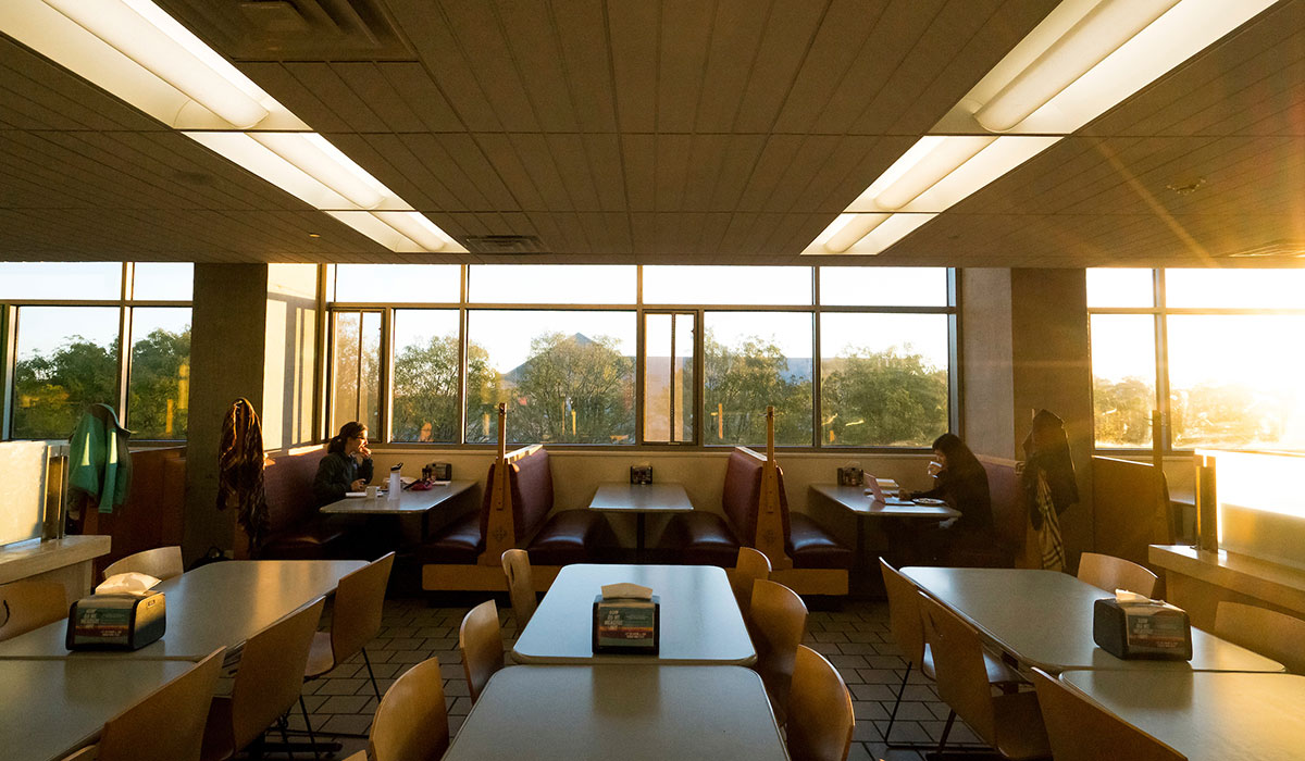 First mosaic photo shows mostly empty tables in the food court of the Edward J. Pryzbyla University Center with the morning sunlight streaming in the windows. 