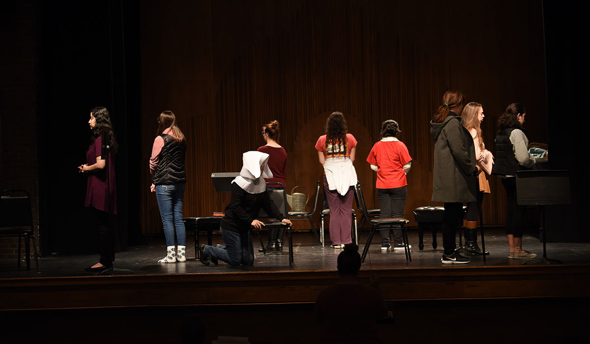 Students on stage during rehearsal